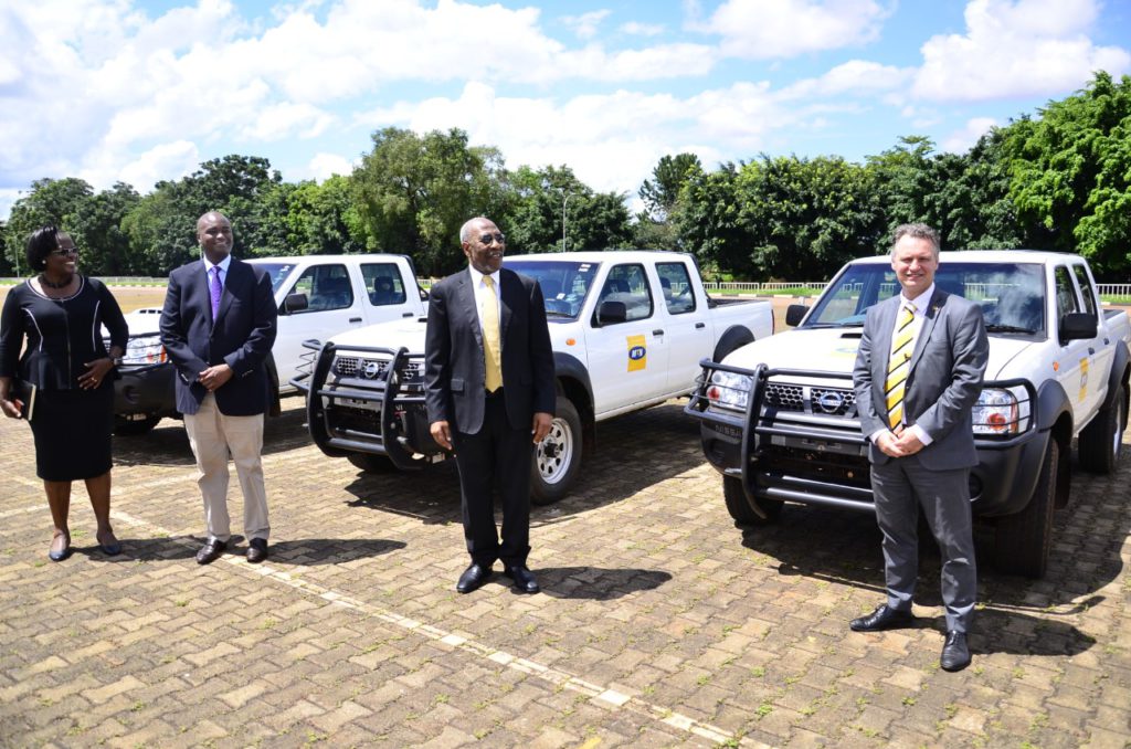 MTN CEO, Wim Vanhelleputte (R) handing over three cars to the Prime Minister Hon. Ruhakana Rugunda (3L) (1)
