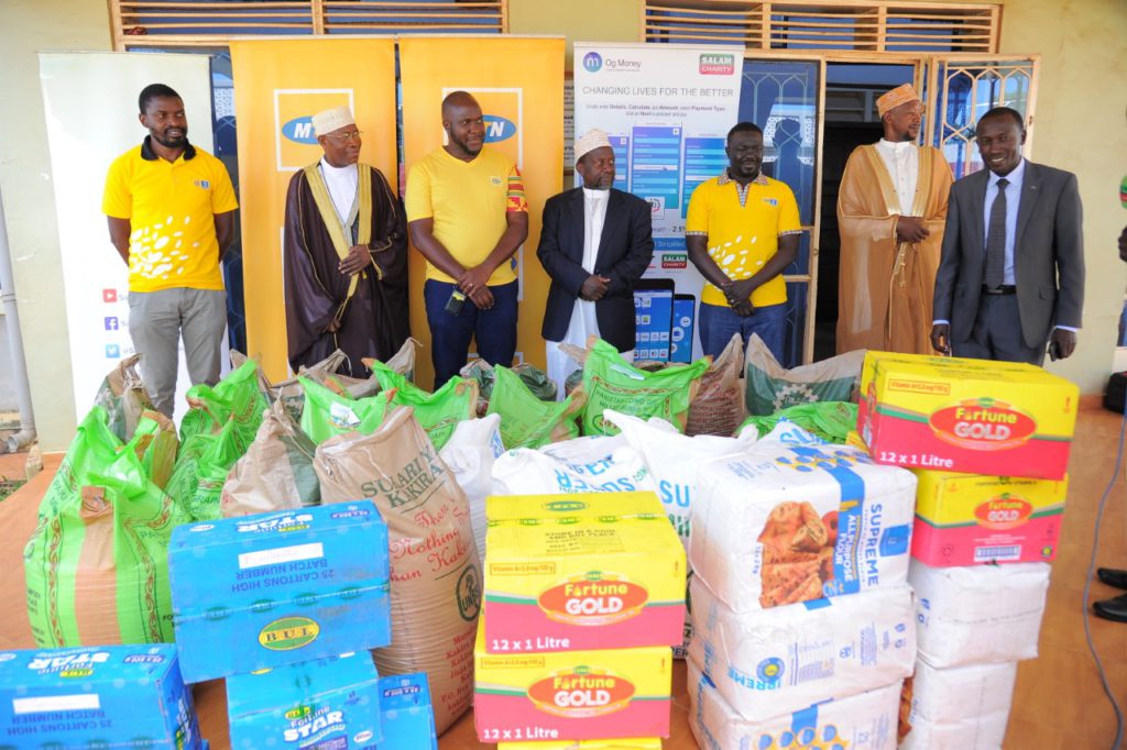 MTN staff hand over food items to the Supreme Mufti, Sheikh Kasule Ndirangwa (2L) at Kibuli mosque
