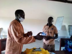Maracha Constituency MP. Denis Lee Oguzu handing over Infrared temperature guns.