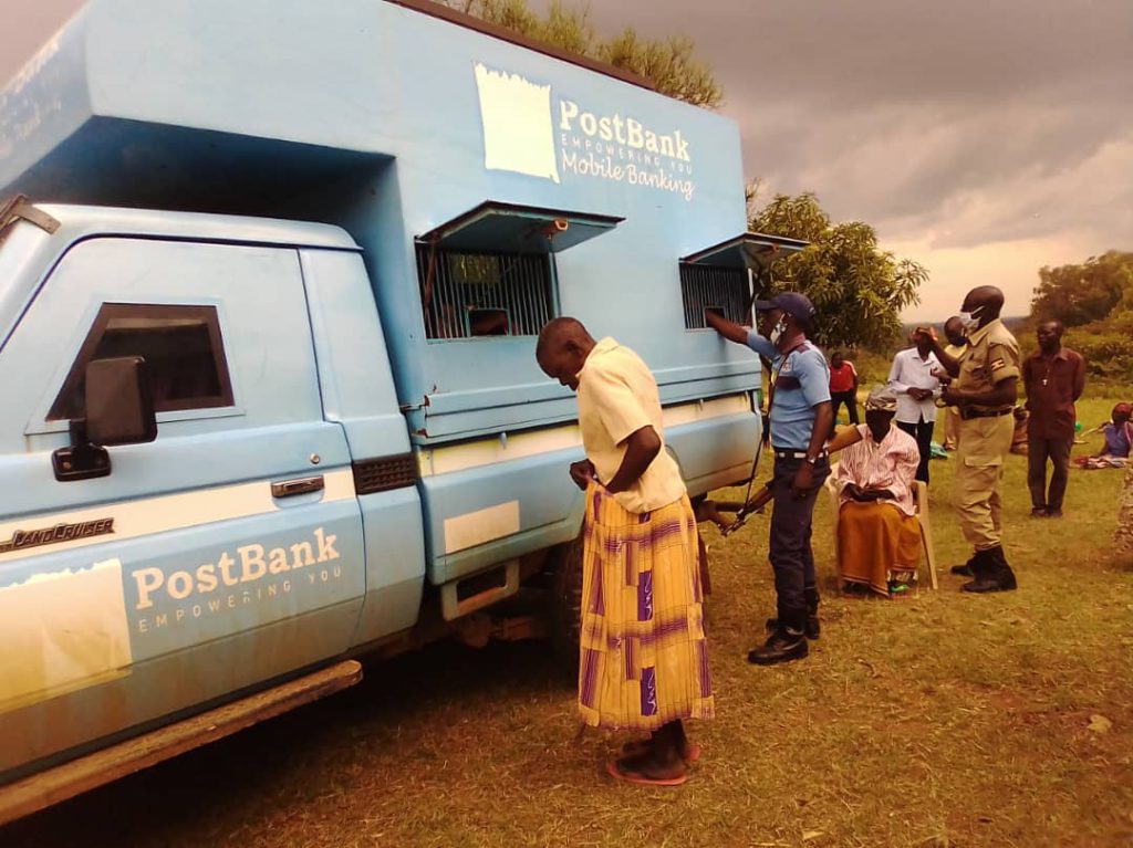 Grandma-Odraru-hiding-her-cash-after-receiving-from-Post-Bank-cashier-from-the-Bullion-Van-at-Nyadri-Sub-County-Headquarter-in-Maracha-district.