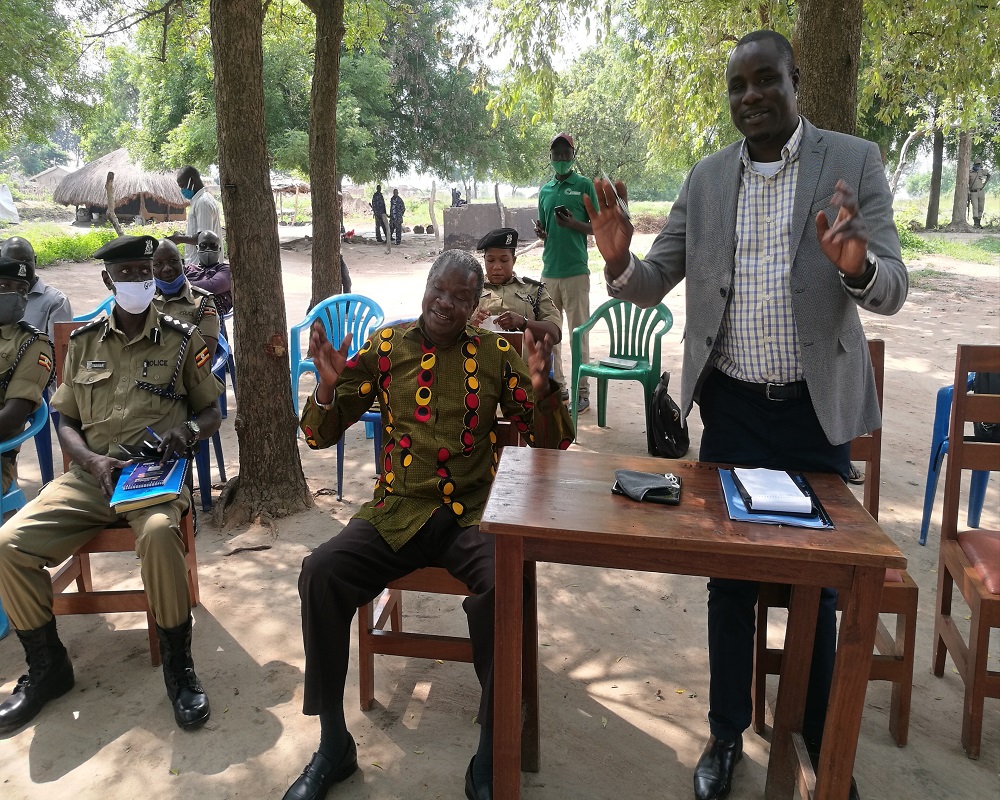 Ogama (R) expresses a point in Kania's agreement as SSP Okullu (L) looked on during the meeting on Sunday