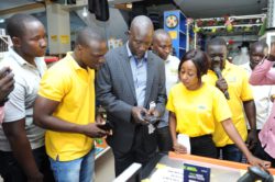 Arua Municipality Mayor Issa Kato (C) paying for his merchandise using MoMoPay during the MoMoPay launch in Arua Town last year (File Photo)