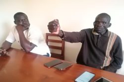 Embati stresses a point as MP Atiku (L) looked on during the press briefing on Sunday
