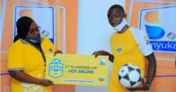 MTN's Barbara Kiwanuka hands over a dummy cheque to the runner up