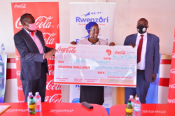 thumbnail_R-L; Simon Kaheru, Coca-Cola Beverages Public Affairs and Communication Director, Hon. Joan Else Adyeeri, Tooro Minister of Tourism and Hon Henry Basaliza Minister Foreign Affairs Tooro kingdom