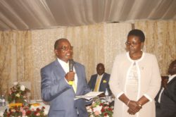 Hon Elijah Mushemeza accompanied by his wife giving his speech at the swearing-in party