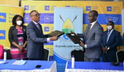 Michael-Mugabi-left-MD-Housing-Finance-Bank-Boss-and-Buganda-Land-Board-CEO-Simon-Kabogozaright-exchanging-the-document-after-signing-ceremony-on-Friday