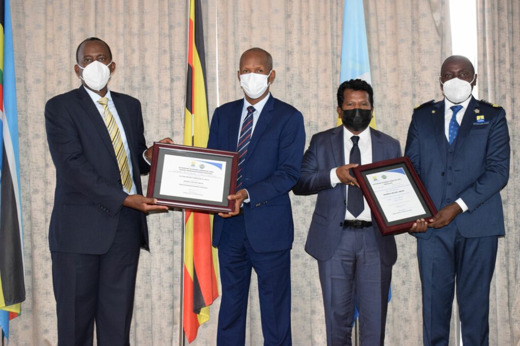 URA CG (left) accompanied by Commissioner Customs Abel Kagumire (right) awarding an AOE certifate at the function on Friday2