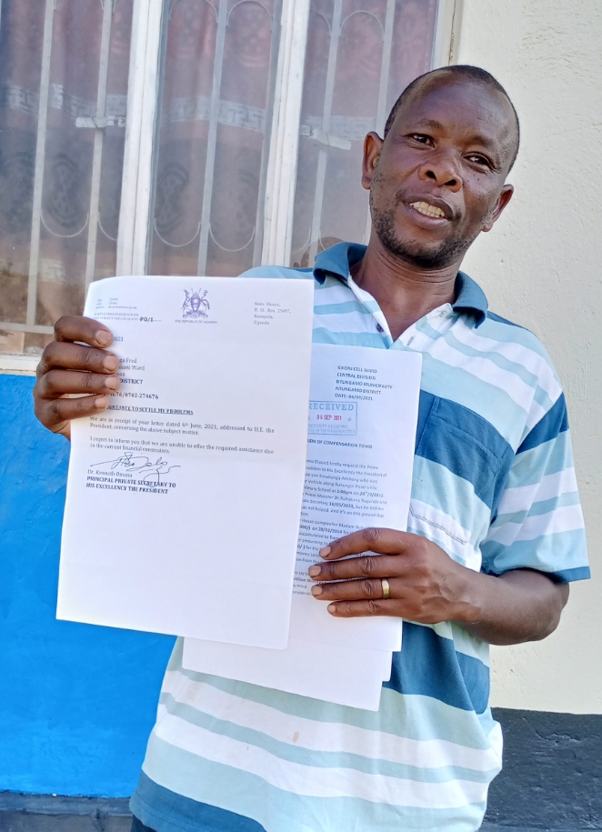 Fred Byaruhanga the complainant desplaying his letters