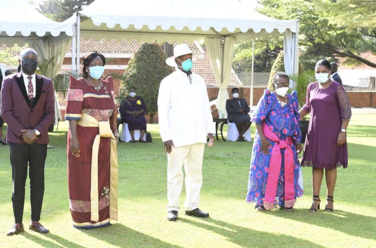 Kadaga flanked by family members is pictured with President Museveni during her swearing in as Deputy PM and EAC minister early this year