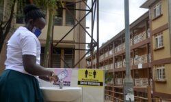 A student washes her hands at a medical school in Kampala