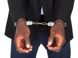 African Man With Handcuffed Hands Isolated On White Background