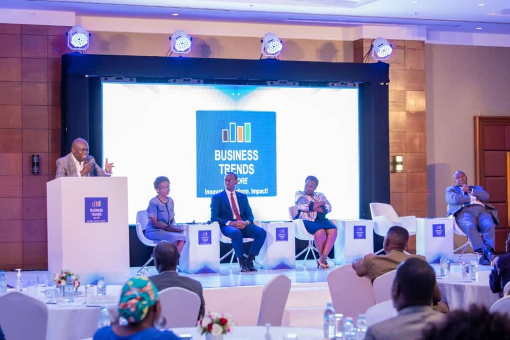 Hajj.Ashraf Simwogerere (on the podium) stresses a point during the panel discussion at the 3rd Business Trendsetters Forum 2022