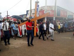 MP Robert Rukari carrying the Cross in the Streets of Mbarara Town during the way of Cross