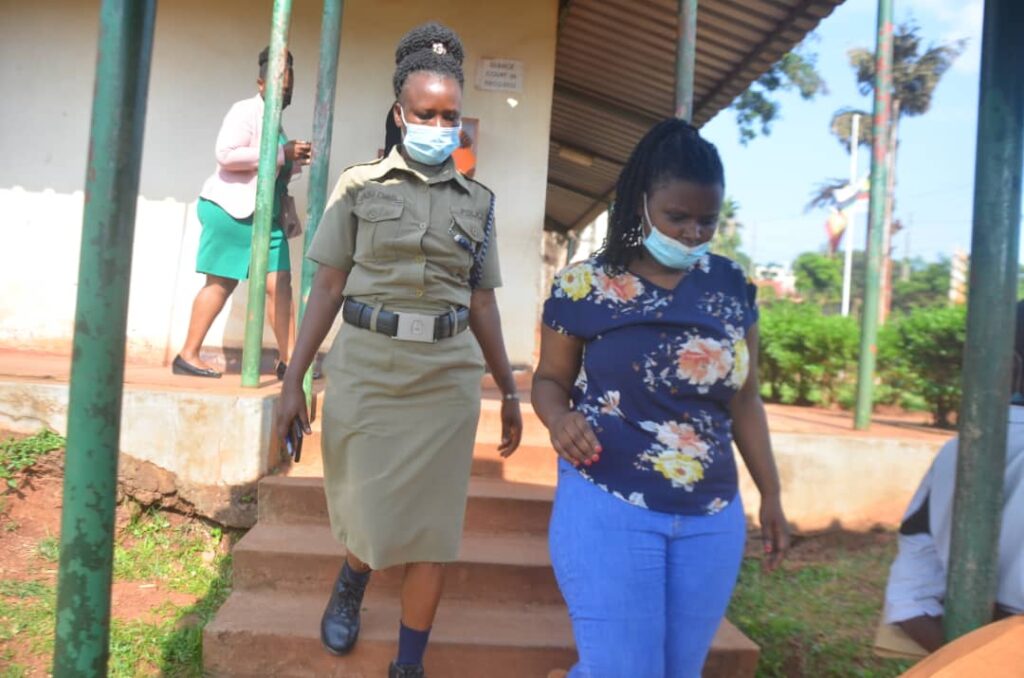 Utamuriza being escorted to board Luzira prison bus