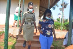 Utamuriza being escorted to board Luzira prison bus