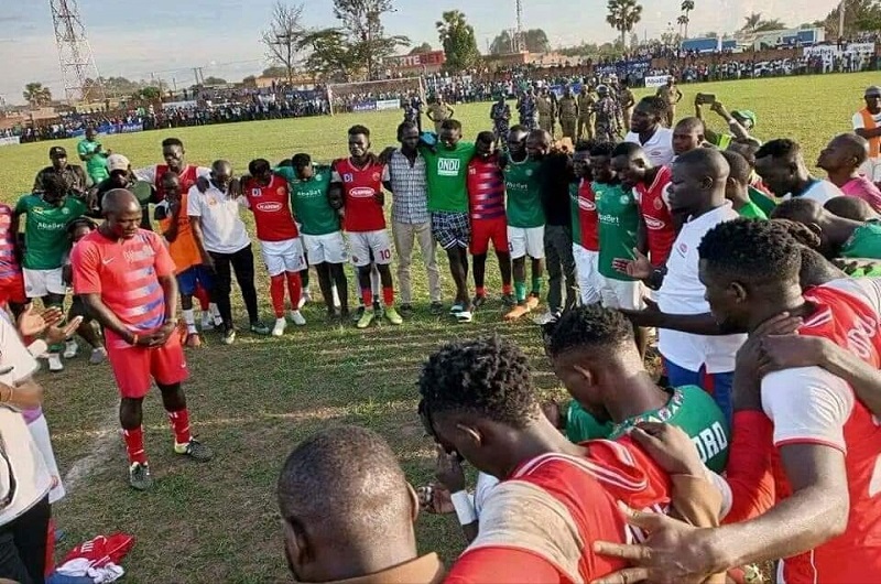Arua Hill SC and Onduparaka FC players and coaches praying together after the game