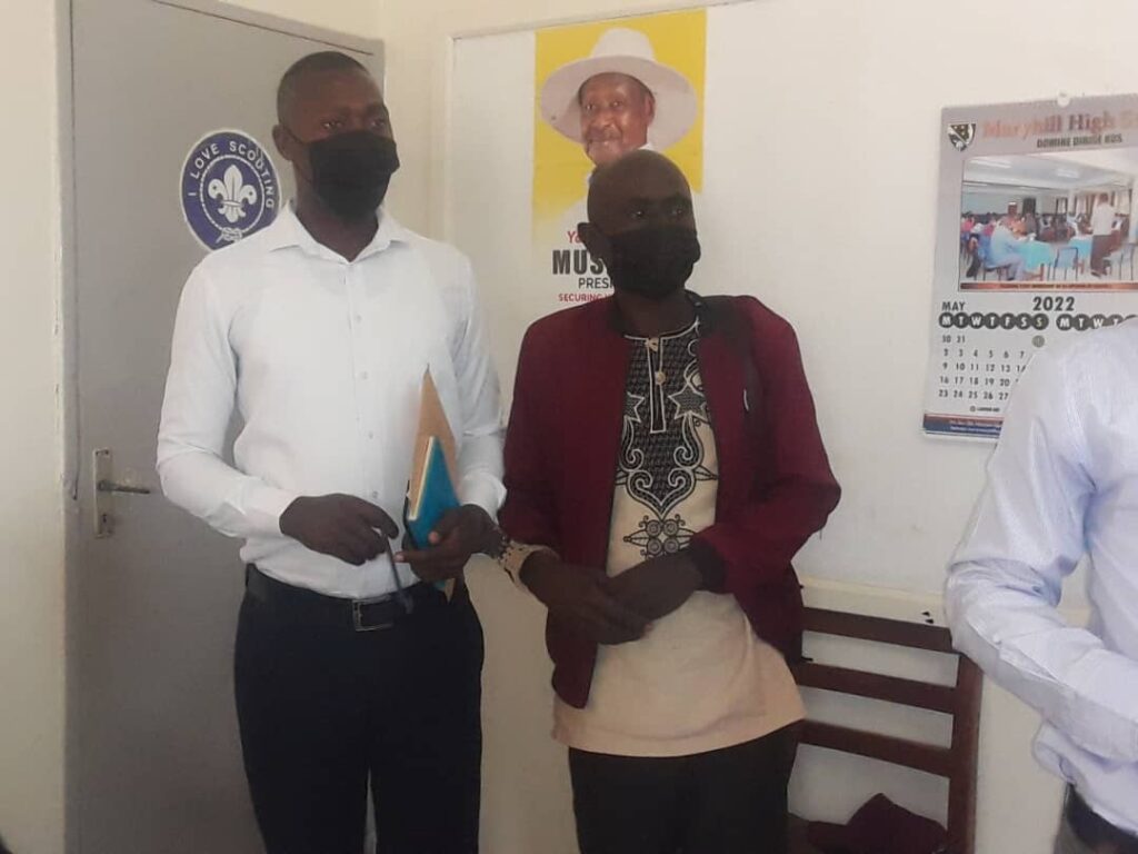 Boaz Byamugisha and Medard Ngabirano at police
