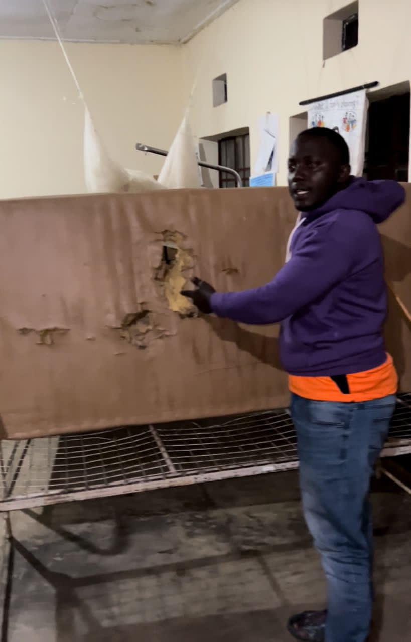 Edwin Nasasira displaying one of the destroyed mattress in the ward at Bitereko Health Center 3s