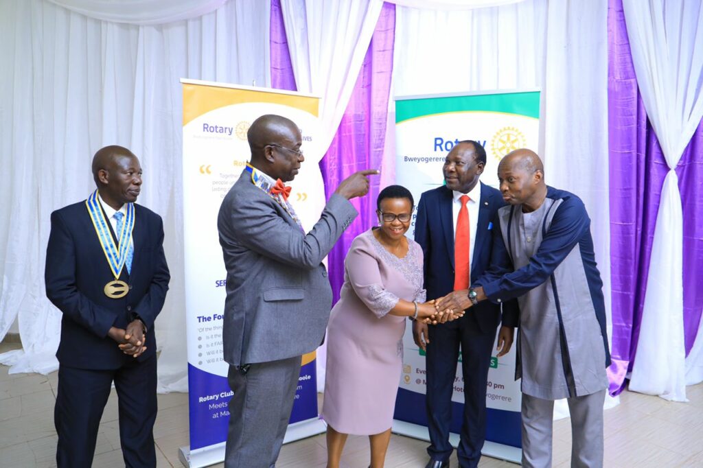 Okol (in a red tie) has been installed as the new President of Rotary Club of Bweyogerere-Namboole