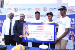 Plascon MD Santosh Gumte (2L), UNF President Sarah Babirye Kityo (2R) and other stakeholders display a dummy cheque on Wednesday.