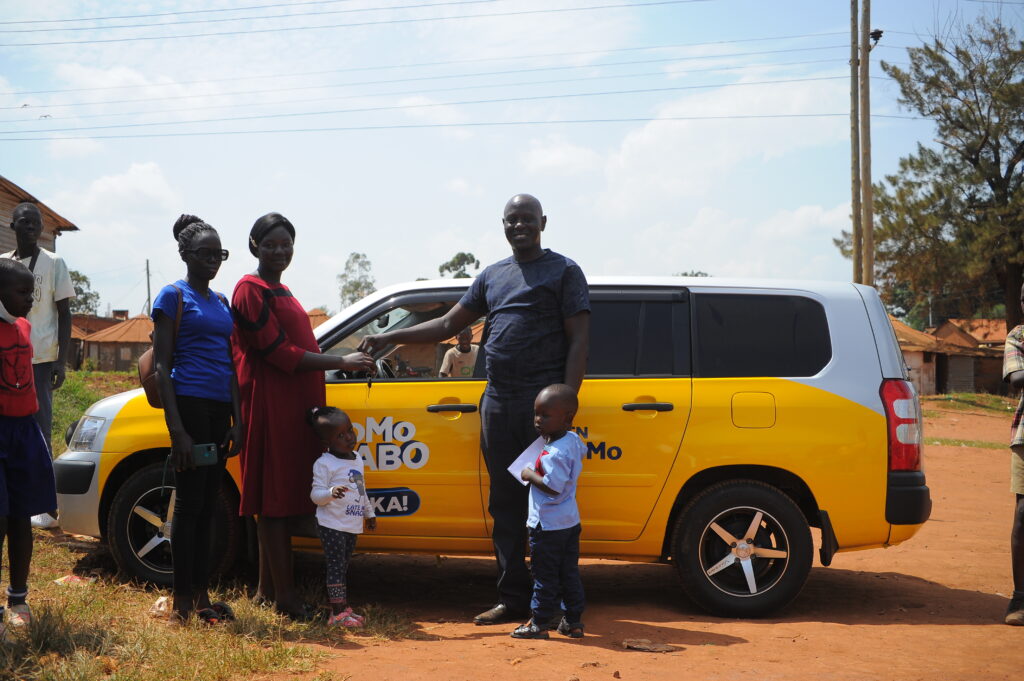 Afande Joseph Okwonji and his family moments before they drove away in a brand new car that Okwonji had won from the MTN MoMo Nyabo Waaka promo