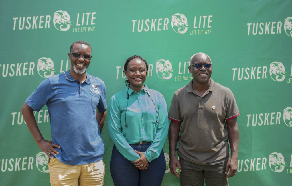 Marathon organizers Robert Kabushenga (right) and Amos Wekesa (left) pose for a photo moment with Tusker Lite Brand Manager Elizabeth Mutamuliza after the launch.