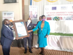 Principal Judge Zeija, Dr. Ssewanyana handing over an award to BSU staff led by Vice Chancellor Prof Kamatenesi