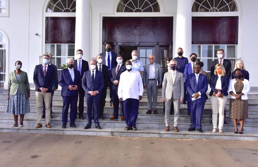 The President (white shirt) in a group photo with the German delegation at State House Entebbe on Tuesday