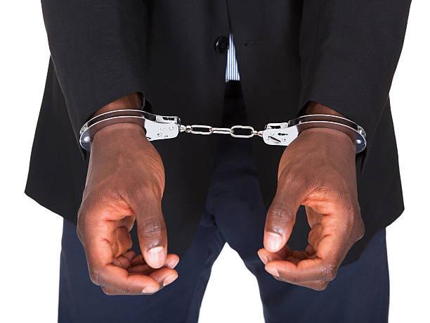 African Man With Handcuffed Hands Isolated On White Background