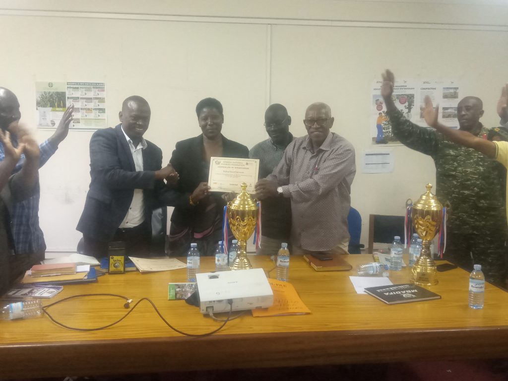 District Chairman handing over certificate to BSU Staff