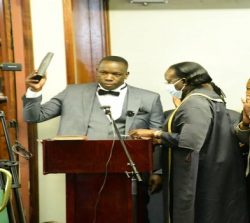 Orone (holding Bible) takes oath following his re-election