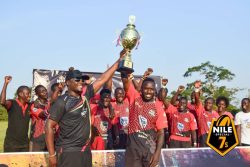 Pirates Captain, Ivan Magomu (right, front) hoists the opening circuit trophy together with Nile Special's John Paul Ssemakula on Sunday as other players cheer in the background.