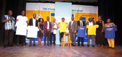 Gender and Culture State Minister Peace Mutuuzo (in the middle holding yellow T-shirt) in a group photo with Board Members of the Initiative