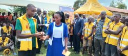One of the winners receives a cash price after the race in Kibaale