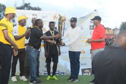 The Kyabazinga of Busoga (in white) and MTN's Joseph Bogera (3L) hand over the trophy to Bukhooli-Namayingo FC who emerged the winners of the 2022 Busoga Cup