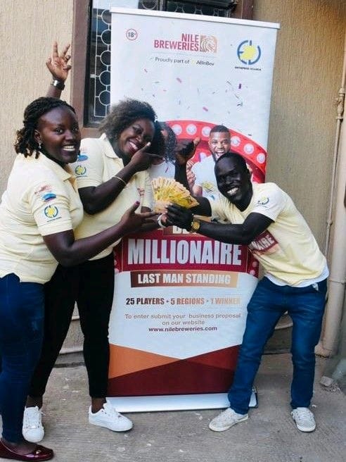 Kenneth Ajok Amor from the North celebrates with NBL staff Clare Asiimwe (L) and Flora Aduk (1)