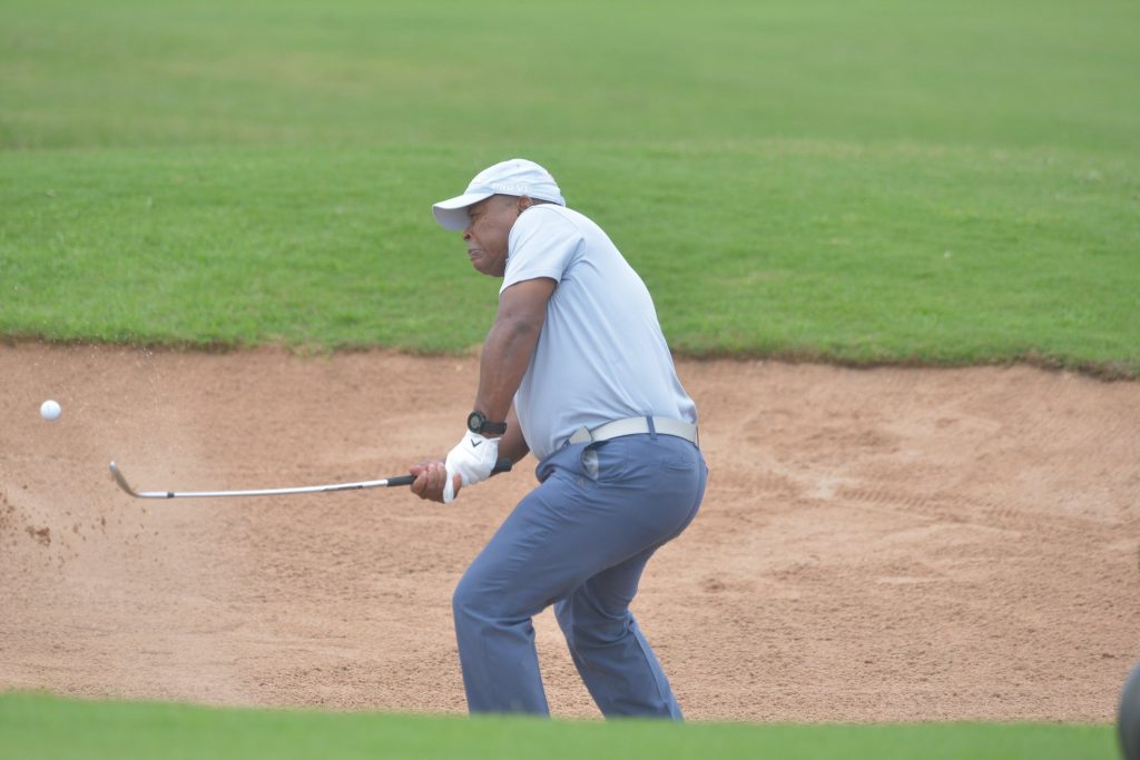 Muchiri scoops his ball off the bunker to the putting green. (1)