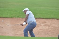 Muchiri scoops his ball off the bunker to the putting green. (1)