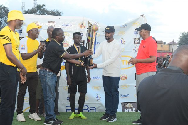 The-Kyabazinga-of-Busoga-in-white-and-MTNs-Joseph-Bogera-3L-hand-over-the-trophy-to-Bukhooli-Namayingo-FC-who-emerged-the-winners-of-the-2022-Busoga-Cup-640x426