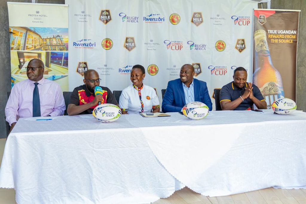 URU's Paul Odong (L) Coach Leonard Lubambula (2L), Women's Rugby rep. Regina Lunyolo (M), LOC's Isaac Lutwama Nsubuga (2R) and Nile Special's John Paul Semakula (R) address media on Wednesday. (1)