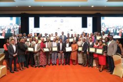 The 24 new companies in a group photo with URA Commissioner General John Musinguzi (middle back row)