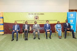 Finance Minister Matia Kasaija (M) flanked by BoU deputy Governor Michael Atingi-Ego (1st left), Arshad Rab (1st right), other stakeholders in a group photo