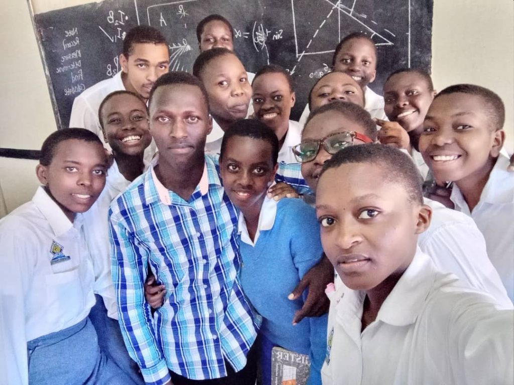 Onesmus Chemutai (fore ground) being swarmed by fellow students at Seeta High