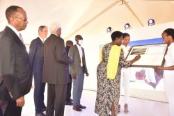 Vice President H.E Jessica Alupo signs a plaque to commemorate the occasion as CBL Chairman Amos Nzeyi (left) and other stakeholders look on
