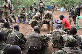Gen Muhanga interacting with UPDF troops in Somalia days after the attack