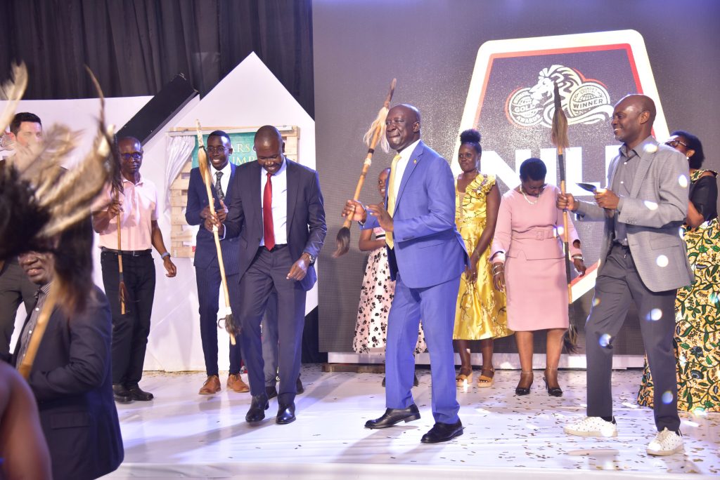 Minister Musa Ecweru, Moses Byaruhanga and Mwenda showcase the Ateso traditional weapons