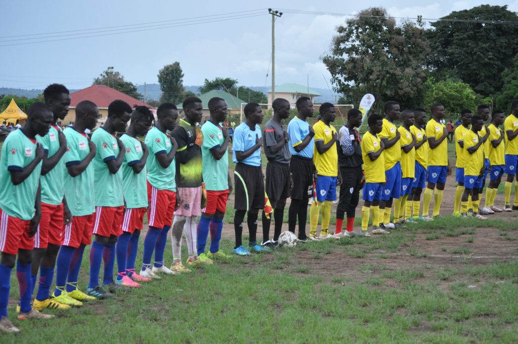 Football teams sing Alur cultural anthem before the match kick started between Padyere and Okoro counties at Luo ground last firday.