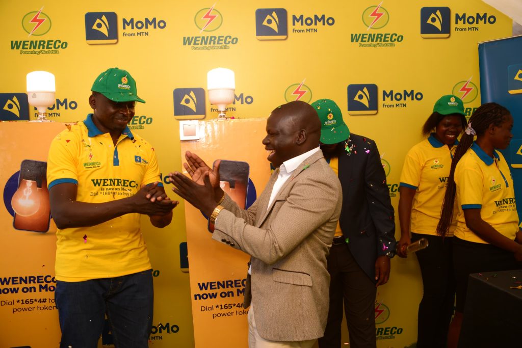 L-R Alex Wekoye, Chief Commercial Officer MTN MoMo and the Arua Deputy RCC. Hamza Ezama Muzamiru celebrating the new milestone
