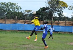One of the strikers of Okoro's team challenged jonam's striker as he jump higher to control the ball with header .photo by patrick okaba.